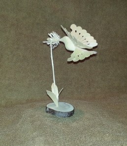The Hummingbird and flower are one piece.  I little more challenging to make.  Flower stem, leaves, and base are separate pieces. This piece is 1 of 4 that turned out.